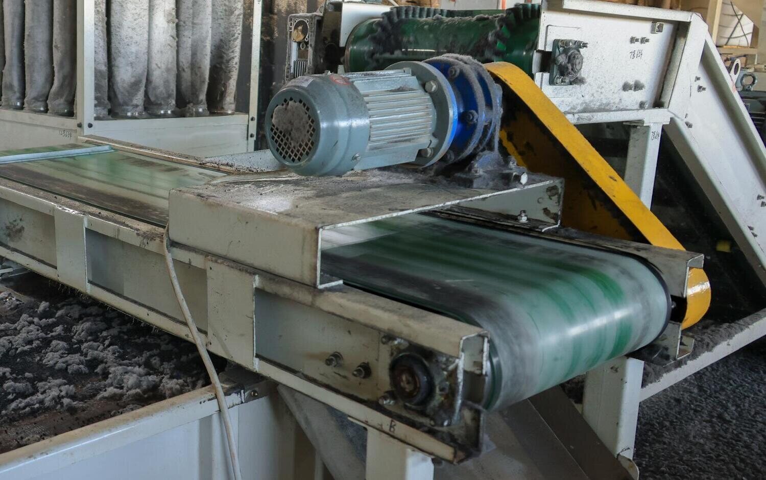 Textile fibre collecting beside a belt on the separation deck at Bedrock's plant